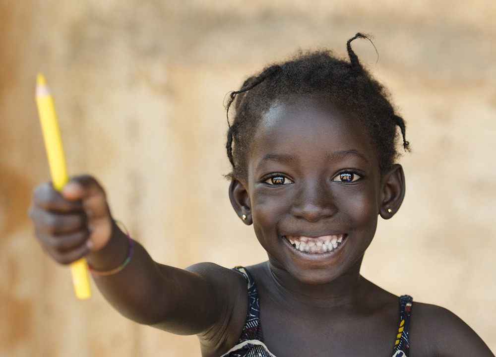 smiling african girl with a pencil